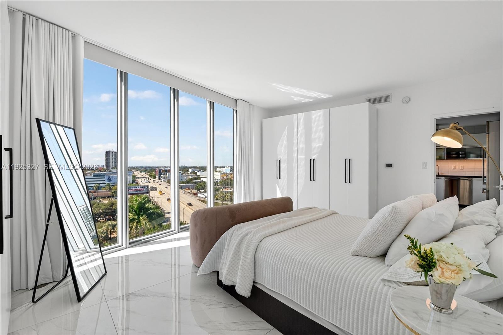 601 Northeast 36th Street, Unit 1101 Miami, FL 33137 - Photo 32 of 69 a bedroom with a bed and a large window