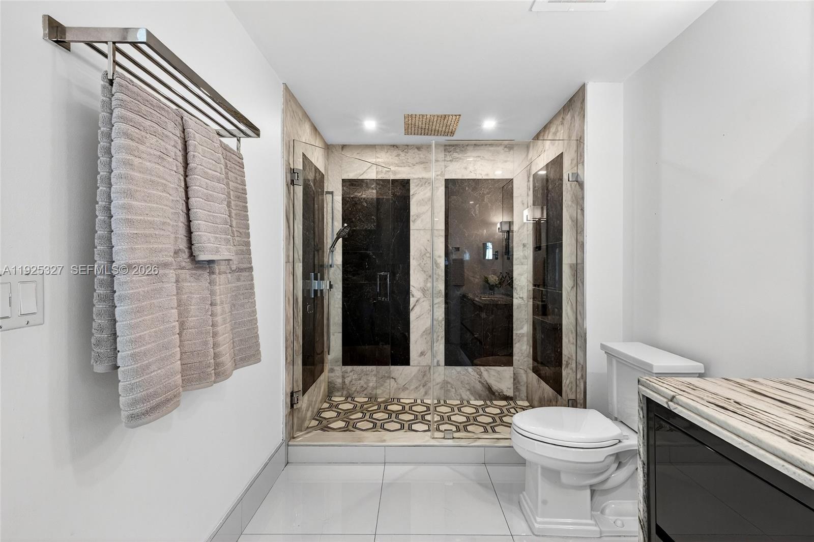 601 Northeast 36th Street, Unit 1101 Miami, FL 33137 - Photo 37 of 69 a bathroom with a toilet a sink and shower