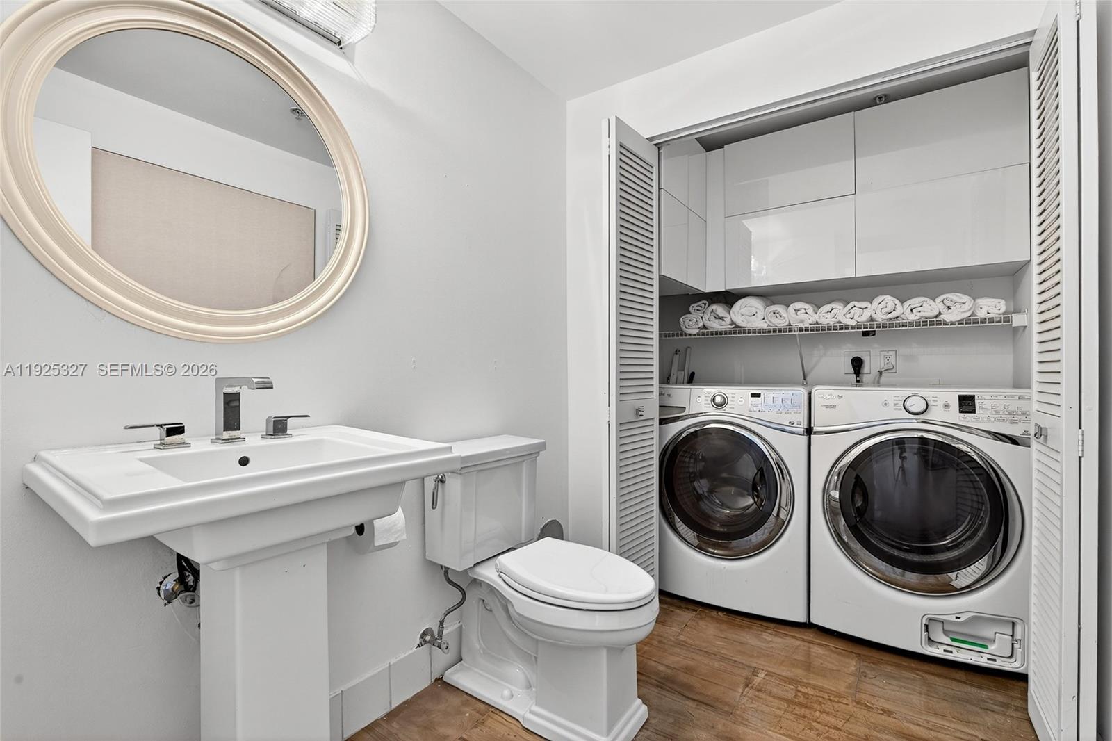 601 Northeast 36th Street, Unit 1101 Miami, FL 33137 - Photo 47 of 69 a bathroom with a sink a mirror and toilet