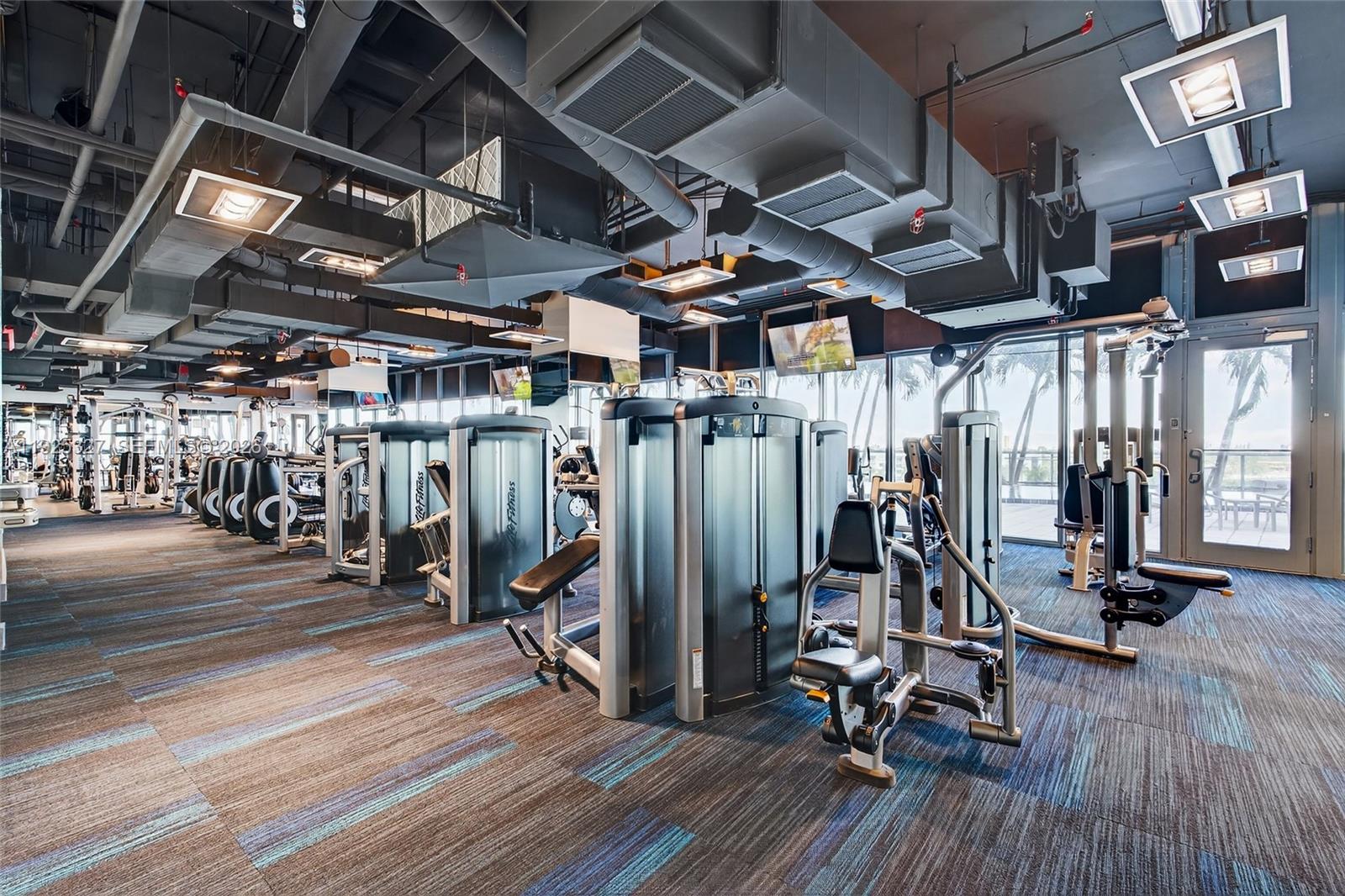 601 Northeast 36th Street, Unit 1101 Miami, FL 33137 - Photo 54 of 69 a view of a room with gym equipment