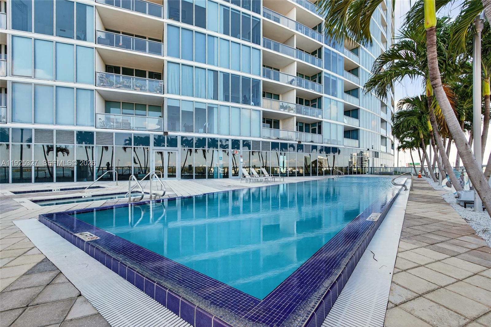 601 Northeast 36th Street, Unit 1101 Miami, FL 33137 - Photo 60 of 69 a view of swimming pool with outdoor seating and house