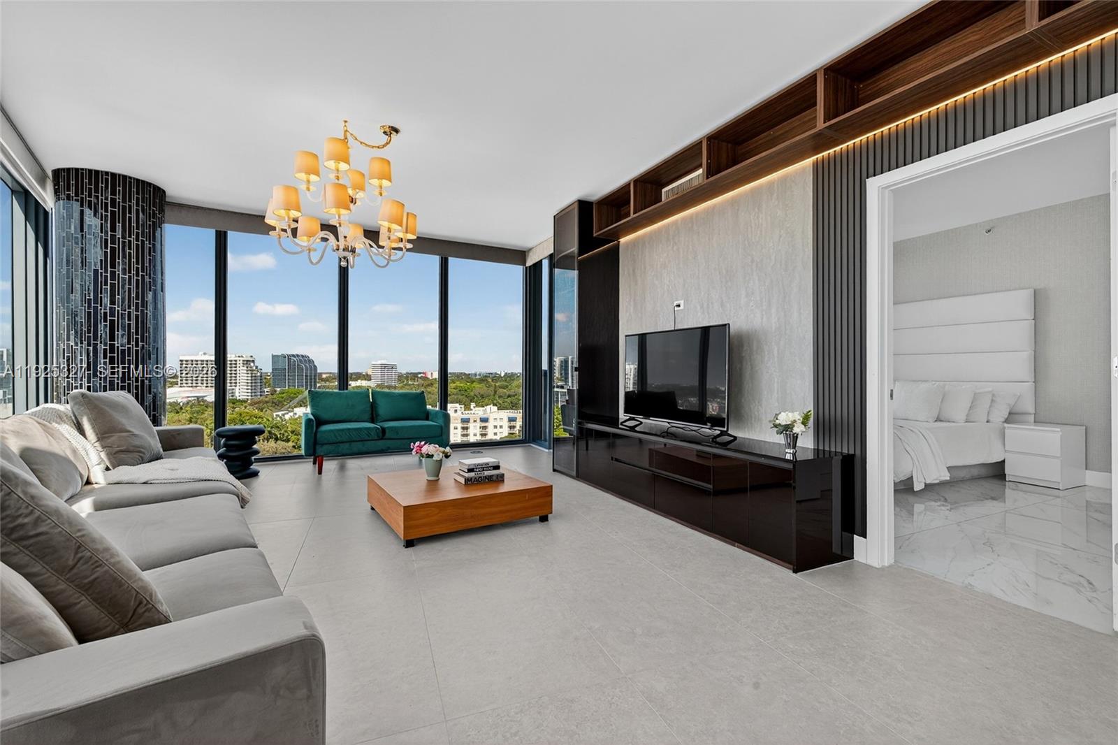 601 Northeast 36th Street, Unit 1101 Miami, FL 33137 - Photo 6 of 69 a living room with furniture and a flat screen tv