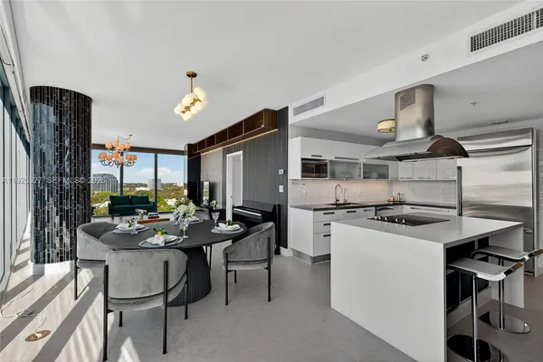 a kitchen with a table and chairs in it