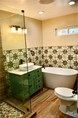 a bathroom with a toilet a sink and window