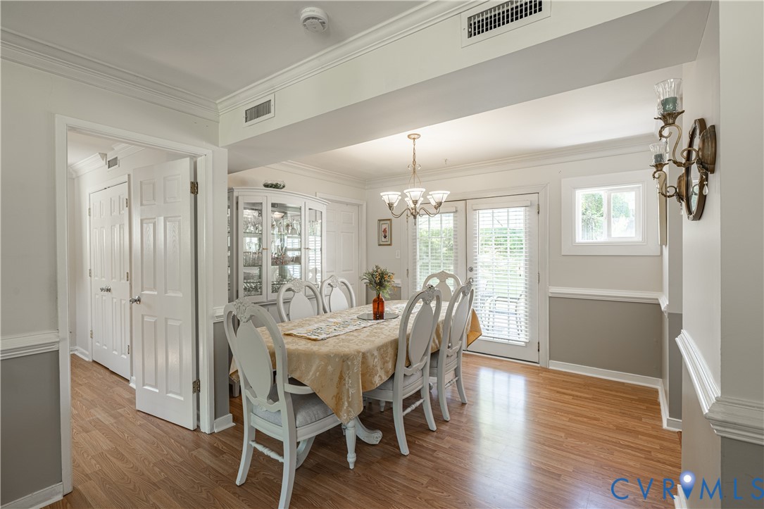 9217 Fisk Road Richmond, VA 23229 - Photo 15 of 39 a view of a dining room with furniture and wooden floor