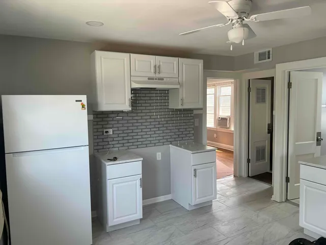 a white refrigerator freezer and a stove