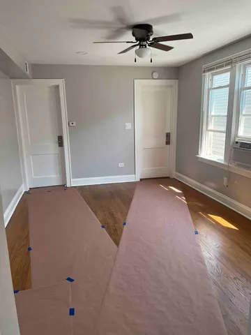 a view of a livingroom with a ceiling fan and window
