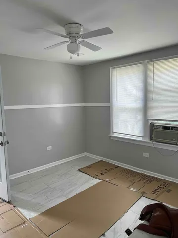 a view of empty room with window and fireplace