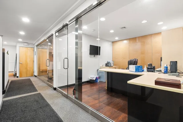 a large white kitchen with a large window and stainless steel appliances