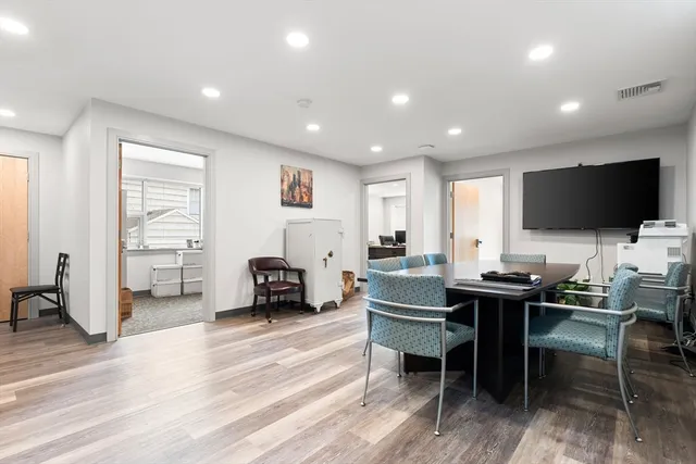 a room with furniture a wooden floor and a flat screen tv