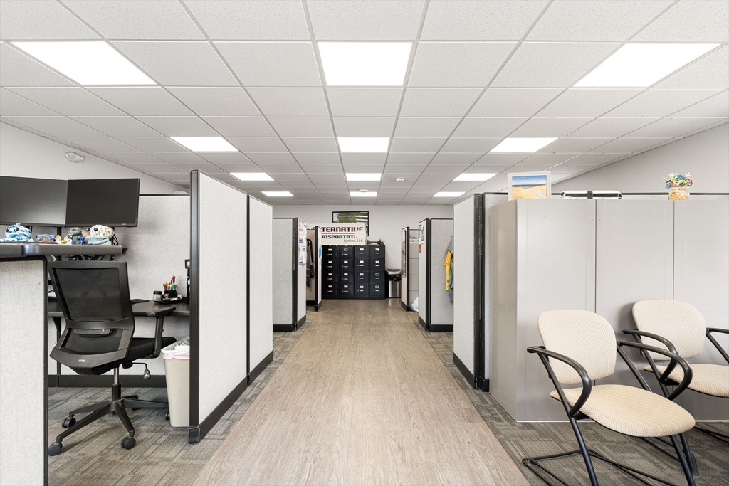 52-56 Dudley Street Arlington, MA 02476 - Photo 32 of 38 a view of a hallway with furniture and a refrigerator