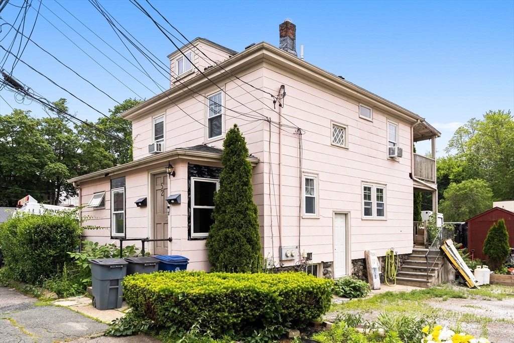 52-56 Dudley Street Arlington, MA 02476 - Photo 37 of 38 a view of a house with backyard and trees