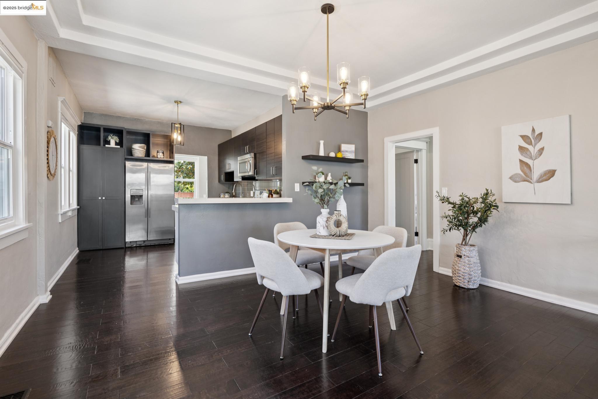 1092 Dwight Way Berkeley, CA 94710 - Photo 12 of 36 Dining space featuring a chandelier and dark wood-style floors