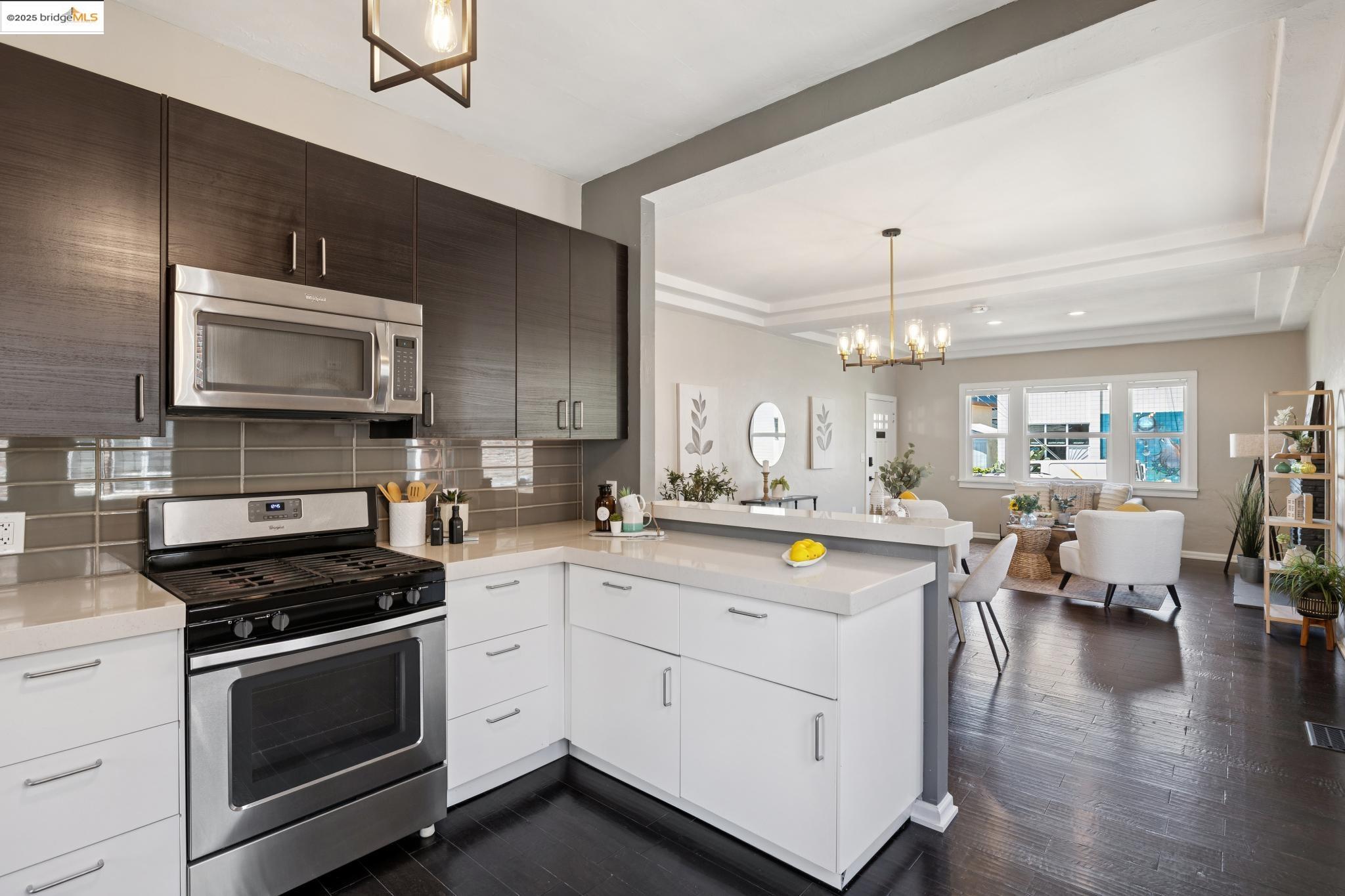 1092 Dwight Way Berkeley, CA 94710 - Photo 36 of 36 Kitchen with pendant lighting, appliances with stainless steel finishes, open floor plan, and dark wood-type flooring