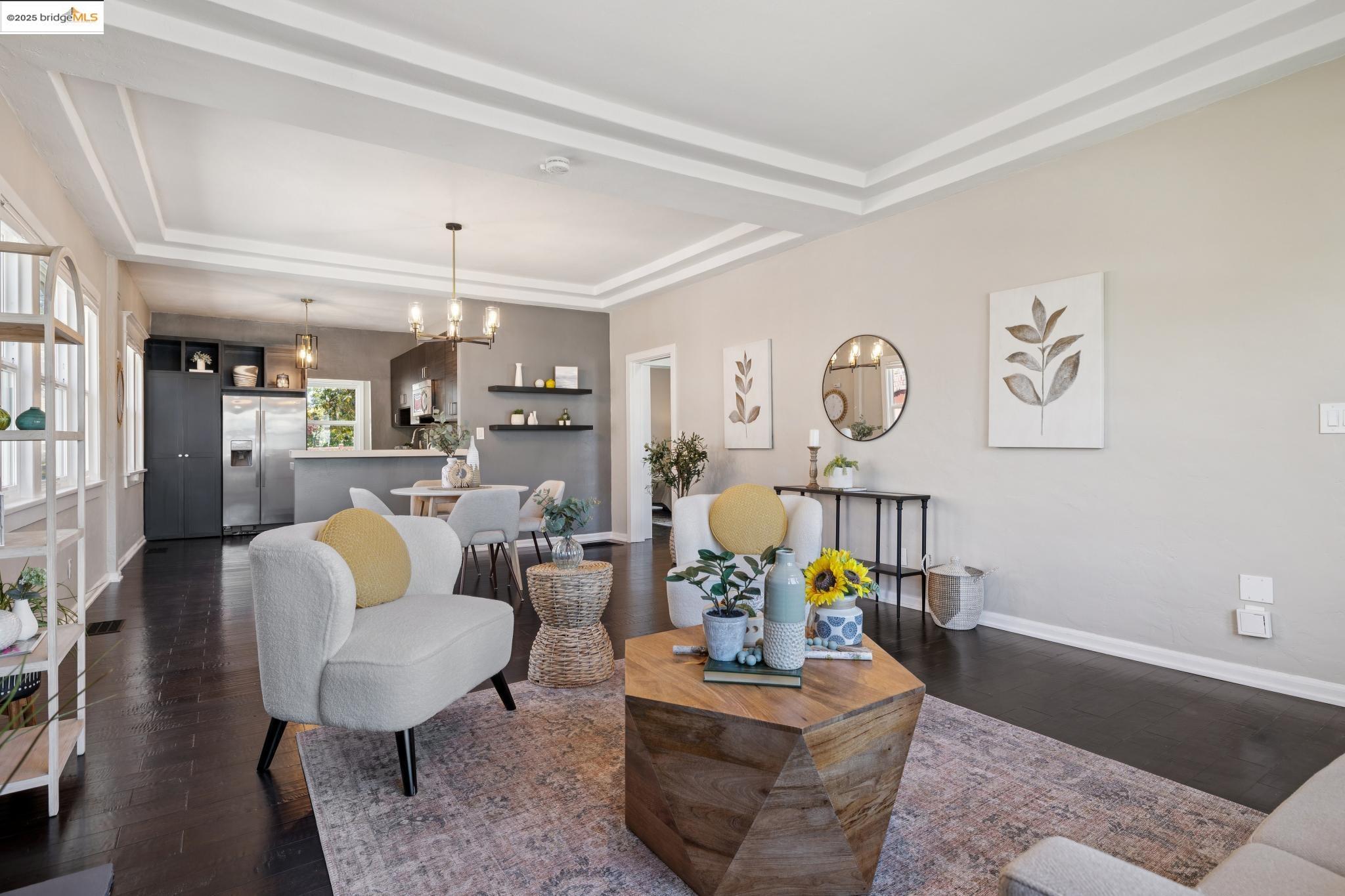 1092 Dwight Way Berkeley, CA 94710 - Photo 7 of 36 Living area featuring a raised ceiling, dark wood-style floors, and a chandelier
