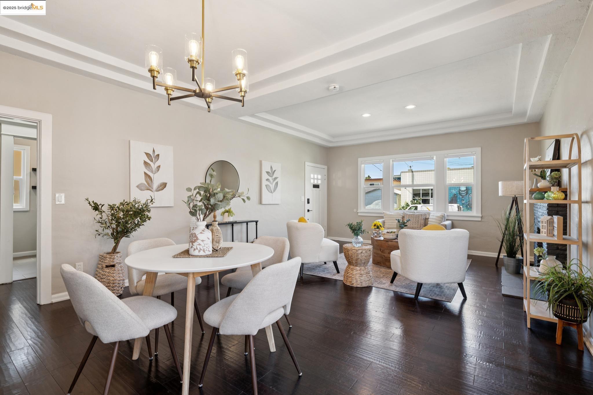 1092 Dwight Way Berkeley, CA 94710 - Photo 10 of 36 Dining area with a raised ceiling, dark wood finished floors, and a chandelier