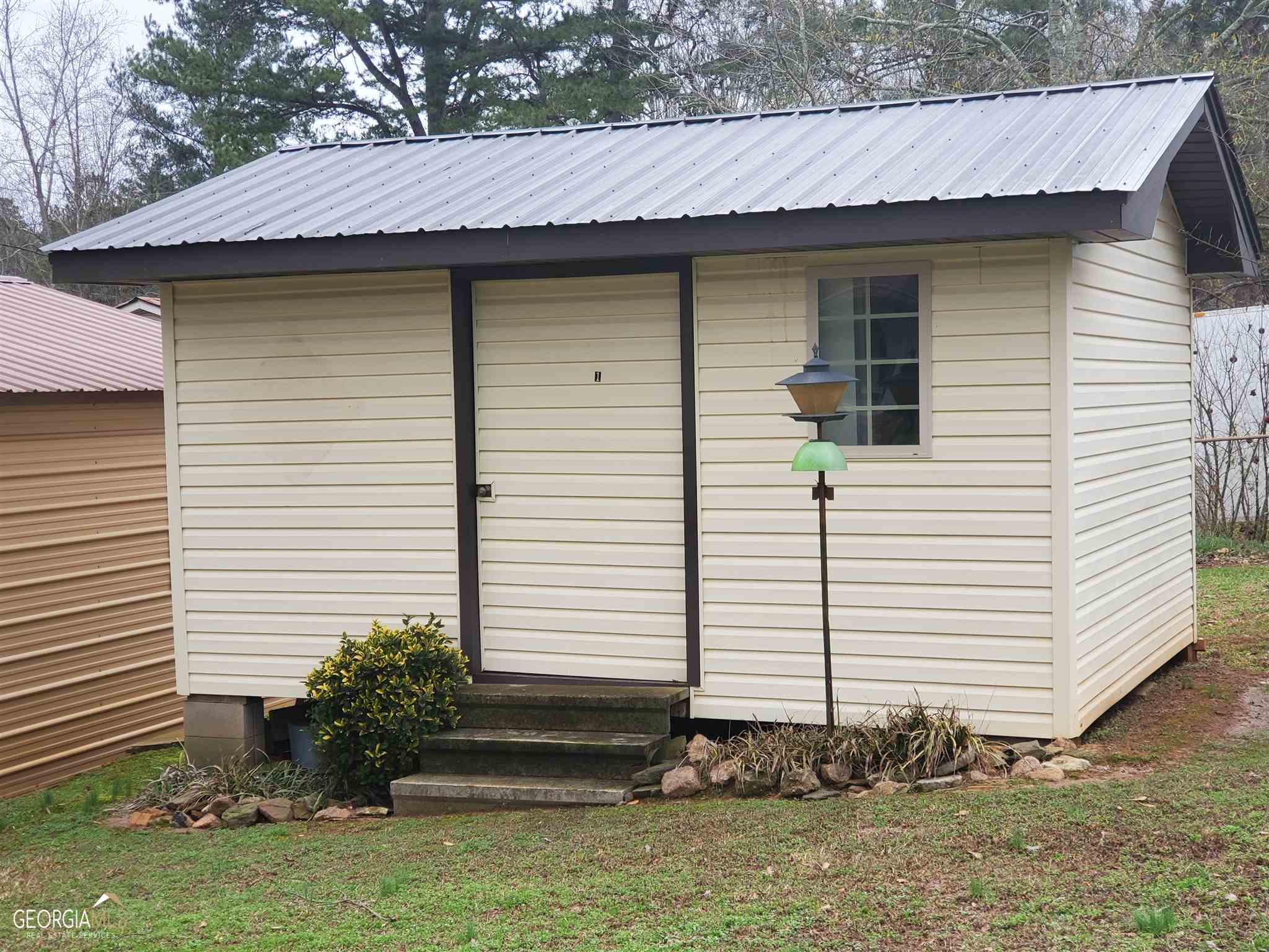 48 Leigh Street Commerce, GA 30529 - Photo 20 of 22 a small white house with a white roof and a yard