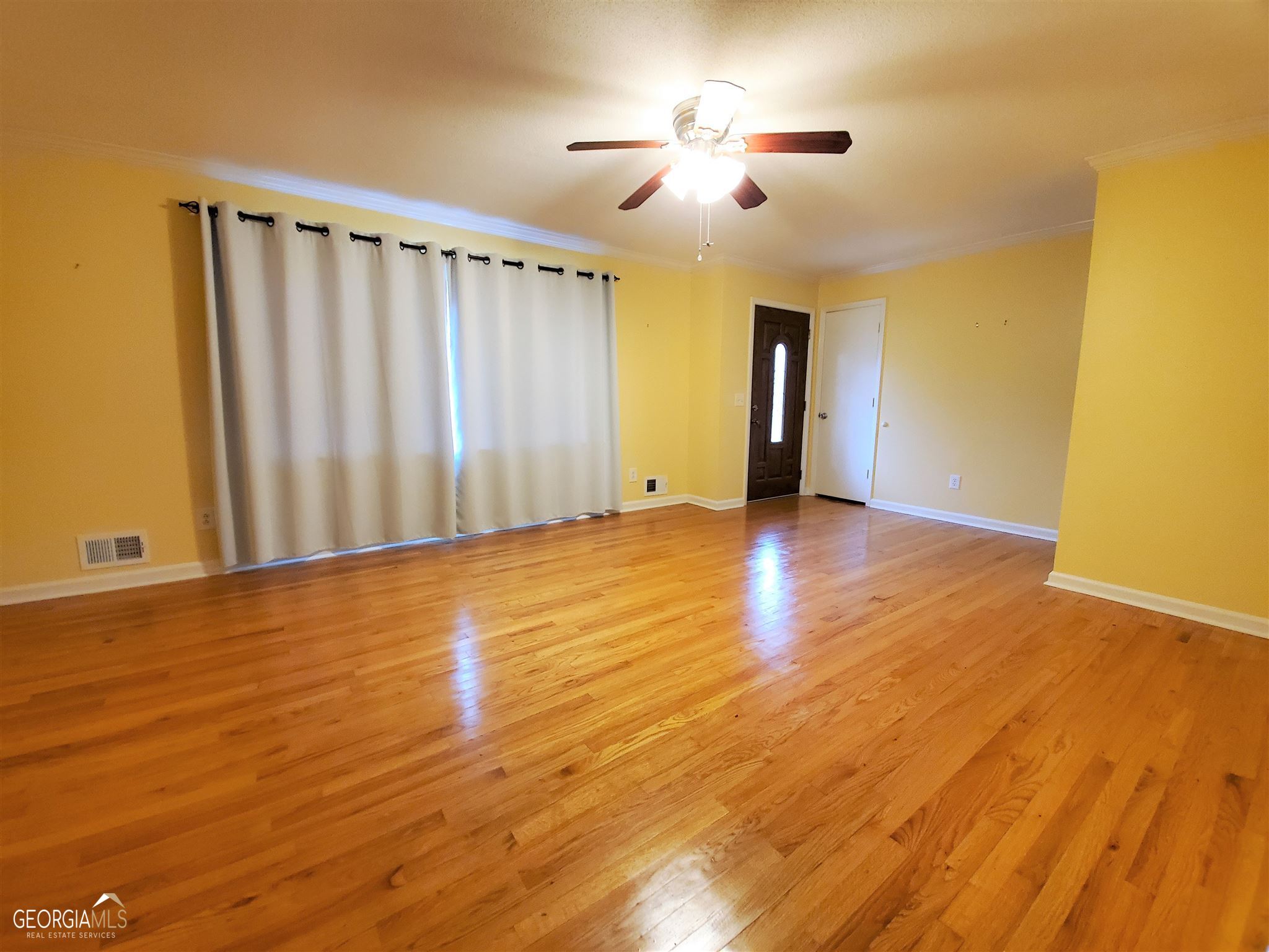 48 Leigh Street Commerce, GA 30529 - Photo 4 of 22 a view of an empty room with wooden floor