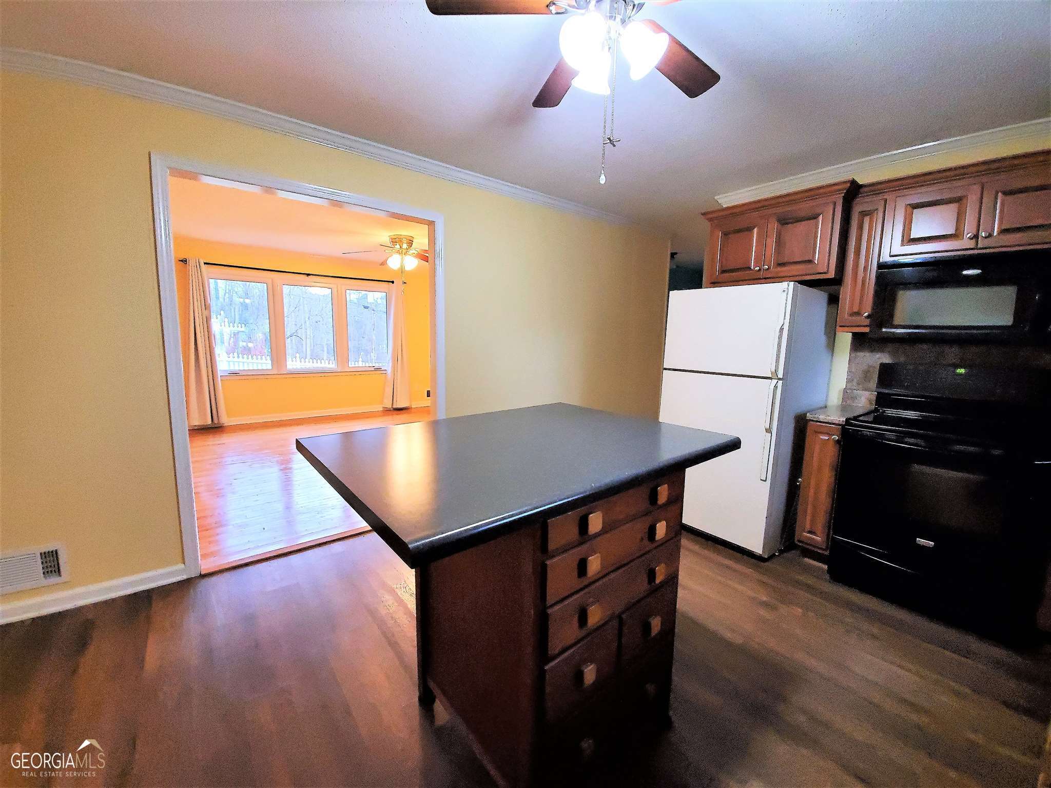 48 Leigh Street Commerce, GA 30529 - Photo 7 of 22 a kitchen that has a table chairs and a refrigerator