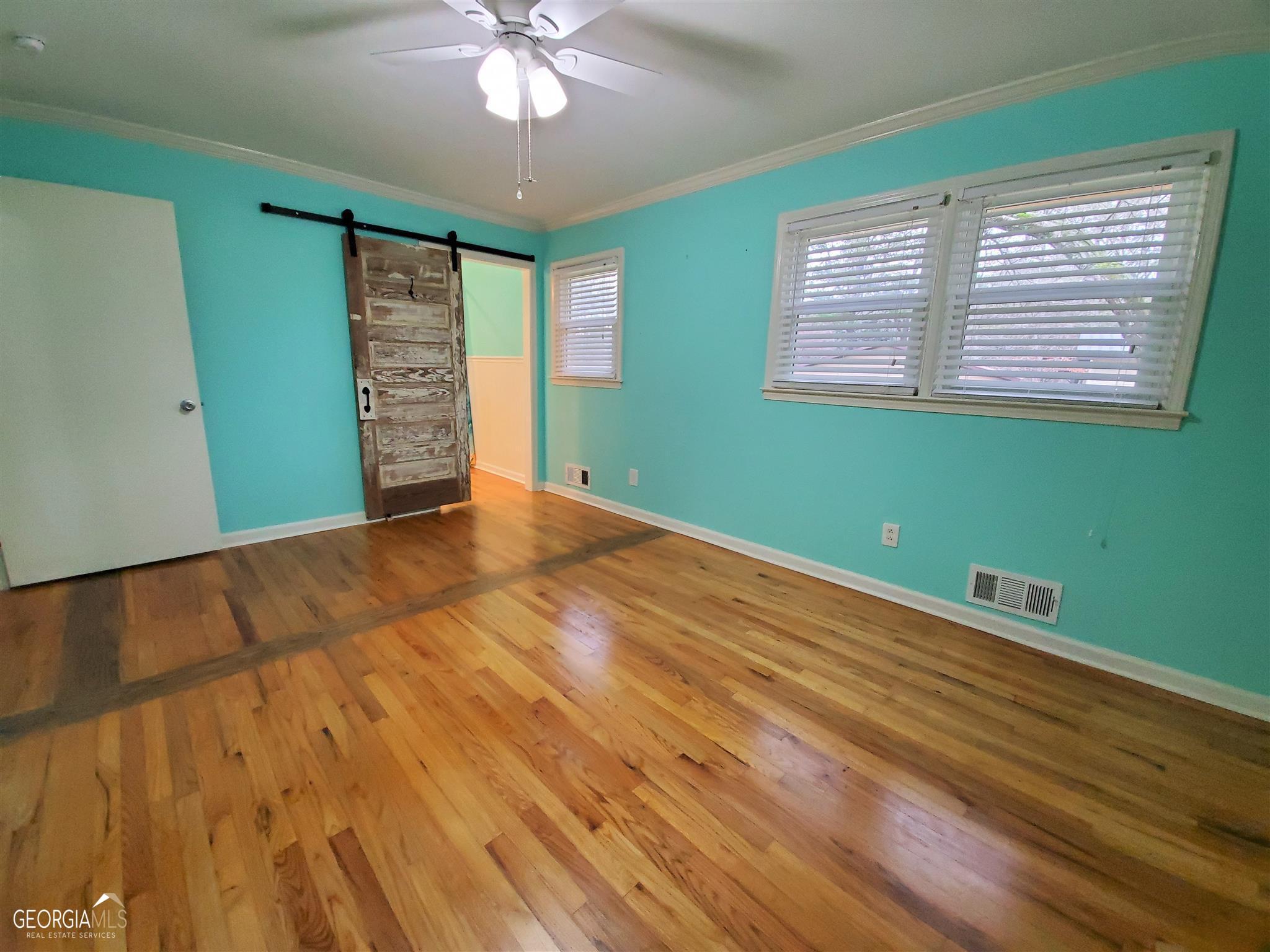 48 Leigh Street Commerce, GA 30529 - Photo 10 of 22 a view of empty room with window and wooden floor
