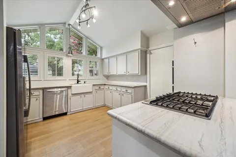 a kitchen with a stove a sink and a refrigerator