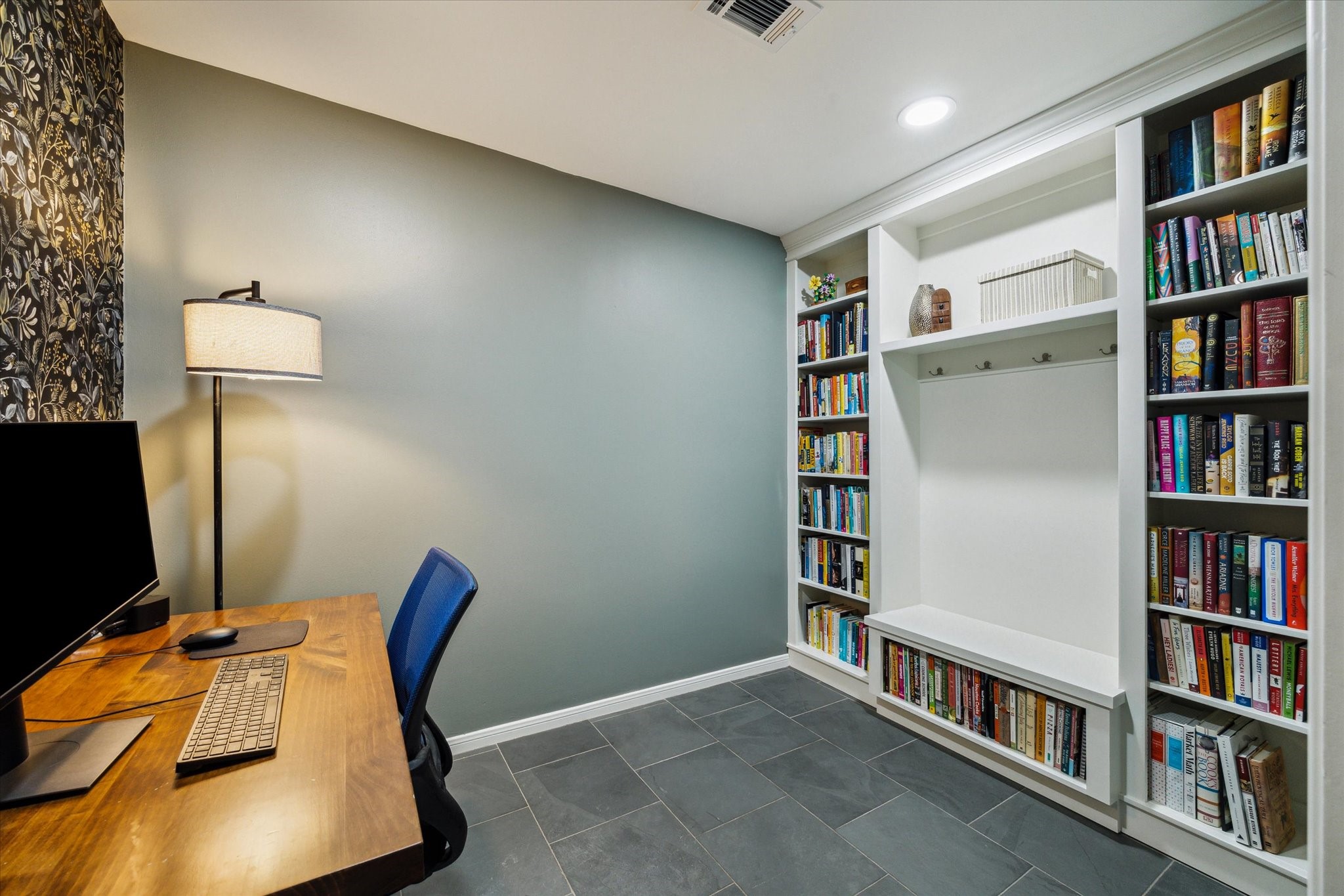 10002 Wickersham Lane Houston, TX 77042 - Photo 15 of 28 a view of a workspace with furniture and a book shelf