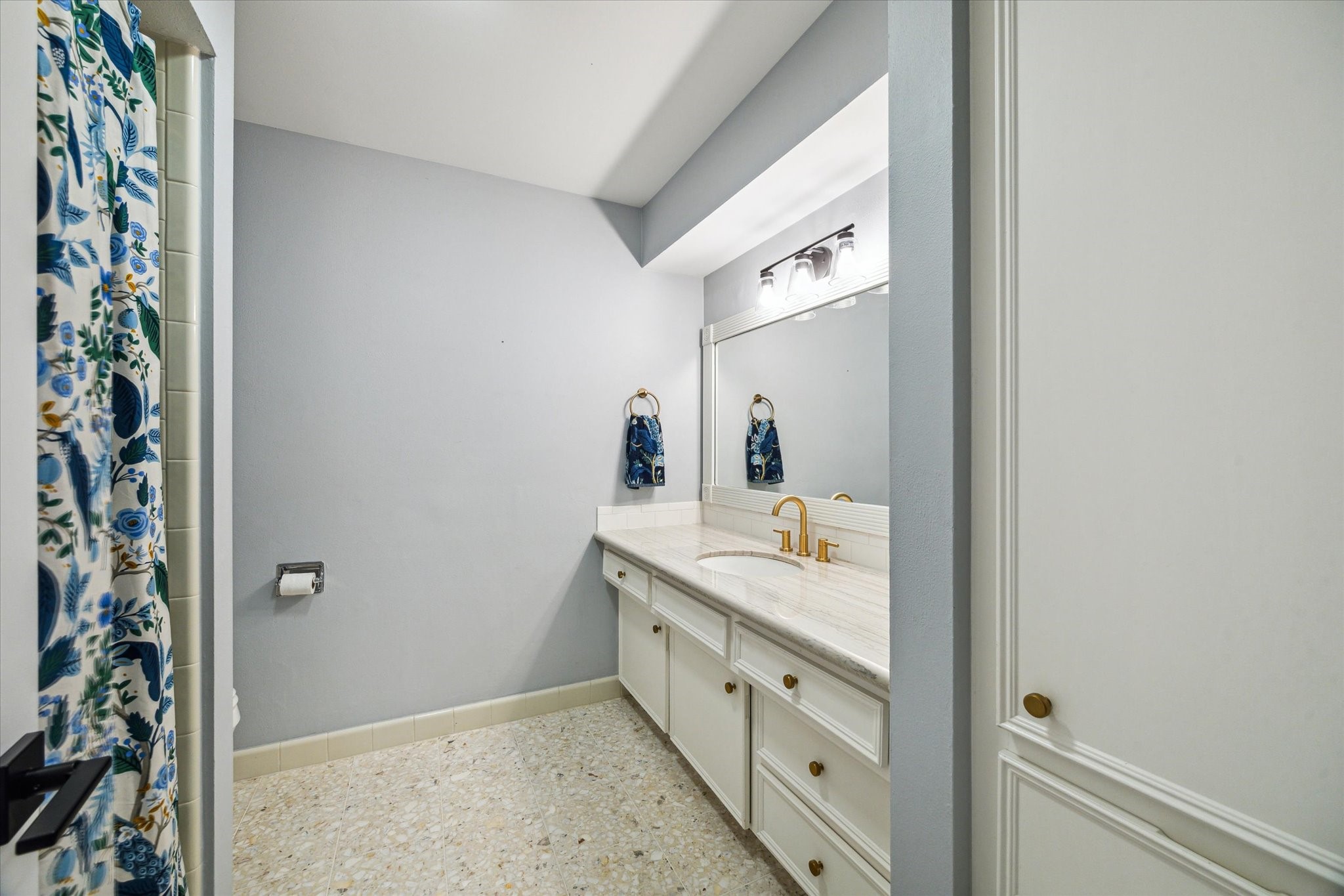 10002 Wickersham Lane Houston, TX 77042 - Photo 18 of 28 a bathroom with a granite countertop sink and a mirror