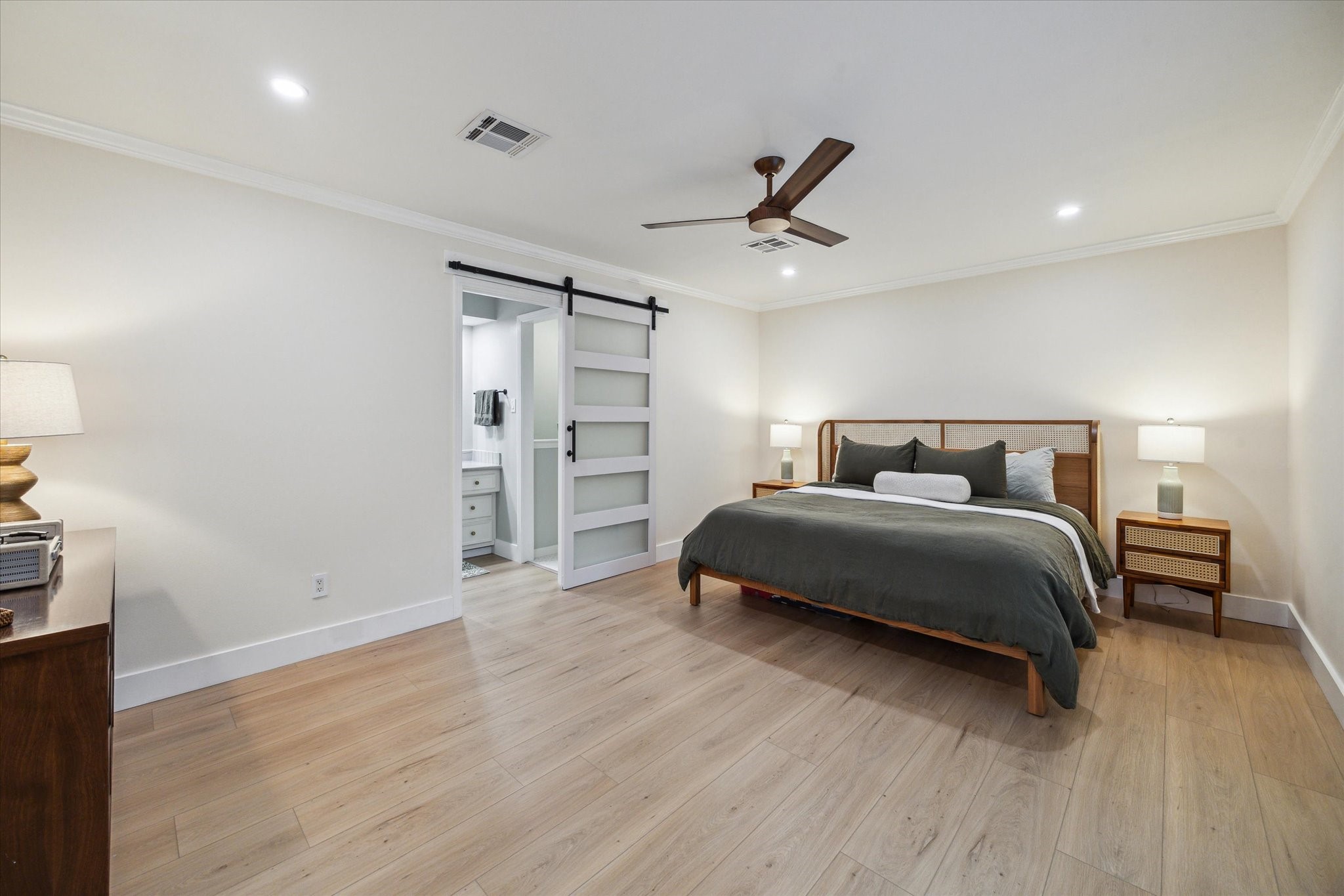10002 Wickersham Lane Houston, TX 77042 - Photo 20 of 28 a bedroom with a bed and wooden floor