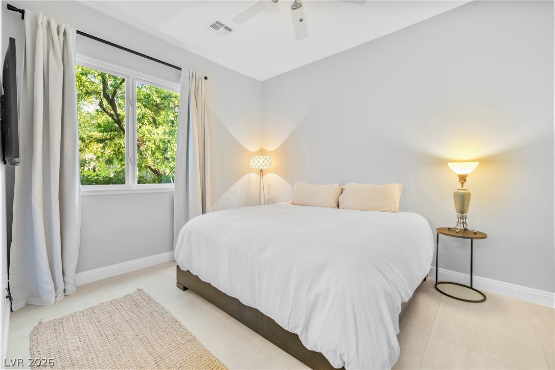 2000 Grouse Street Las Vegas, NV 89134 - Photo 10 of 89 A tranquil sleeping space featuring a large window with lush tree views.