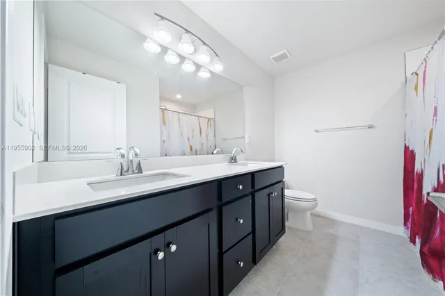 a bathroom with a sink double vanity and a mirror