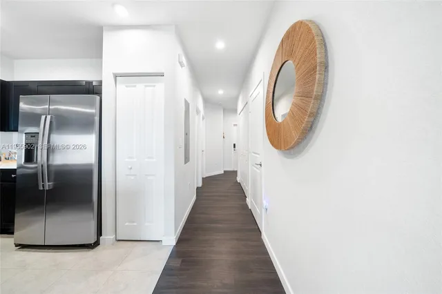 an entryway in a hall with a mirror