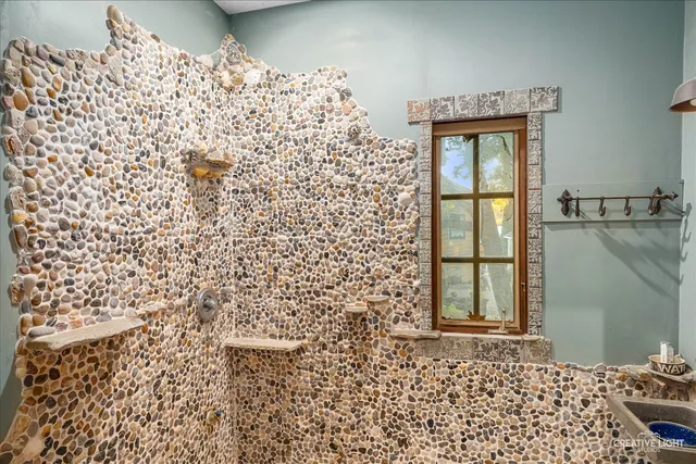 a bathroom with a shower curtain and a window