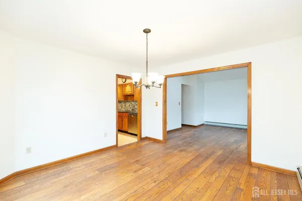 a view of a room with wooden floor closet and a ceiling fan