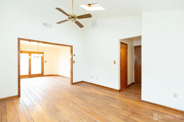 a view of an empty room with wooden floor