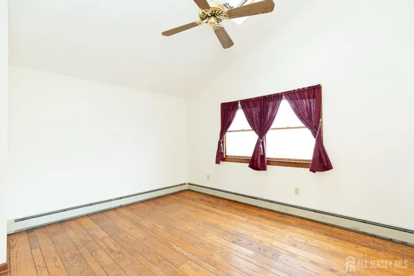 a view of a room with window and a ceiling fan