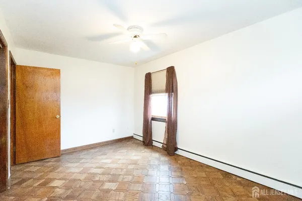 an empty room with closet and entryway