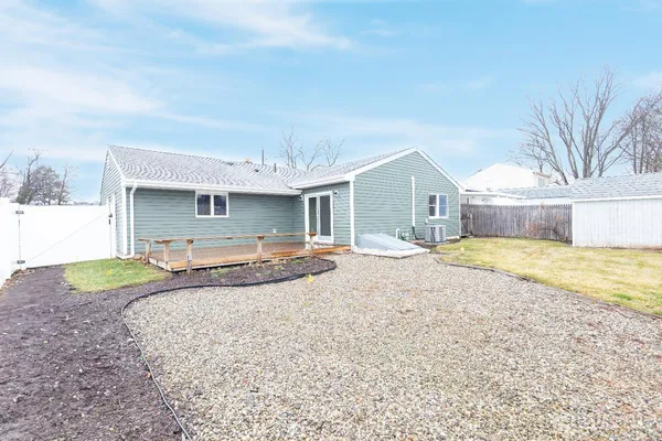 a swimming pool with outdoor seating and yard