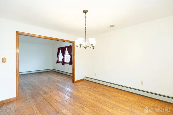 a view of a room with wooden floor ceiling fan