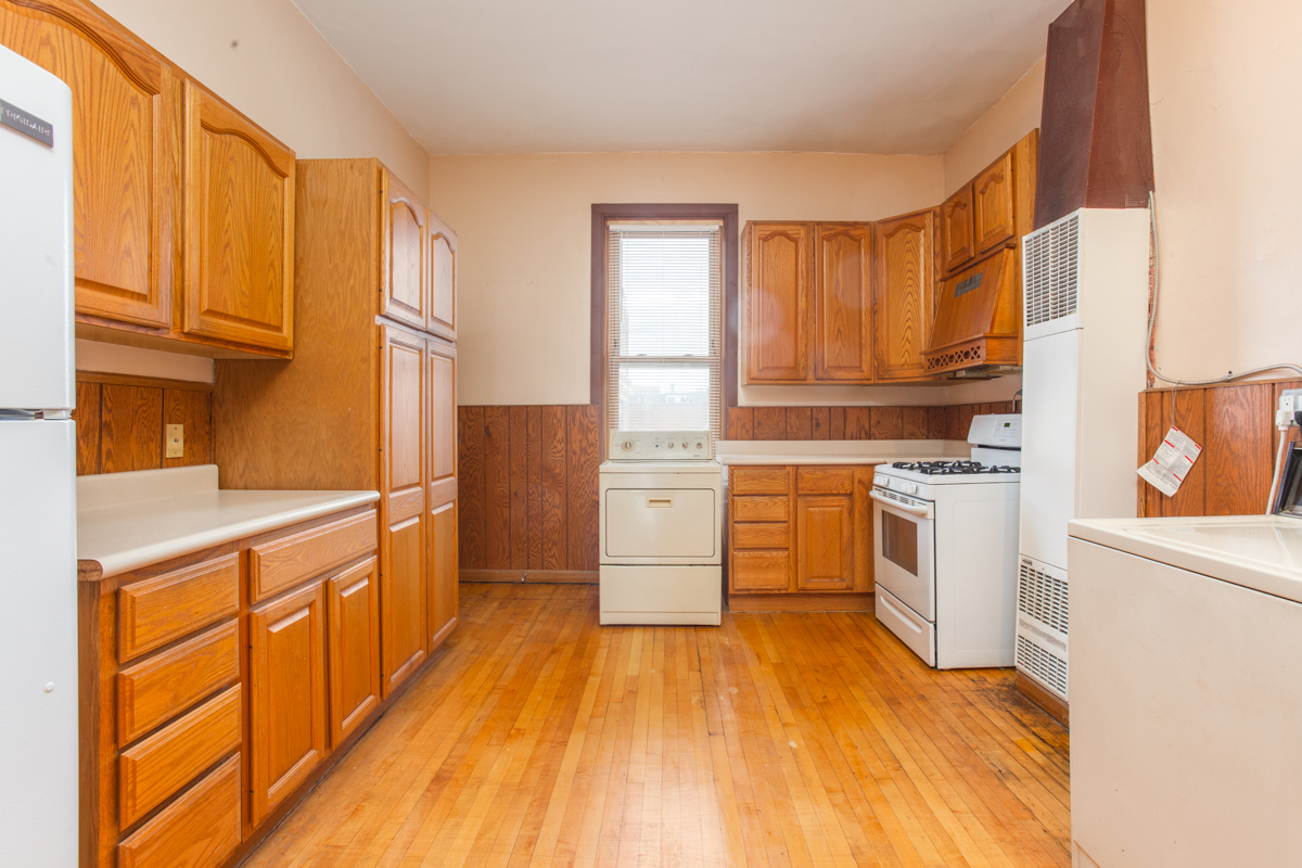 652 West Webster Avenue, Unit 2 Chicago, IL 60614 - Photo 5 of 11 a kitchen with granite countertop wooden floors and white stainless steel appliances