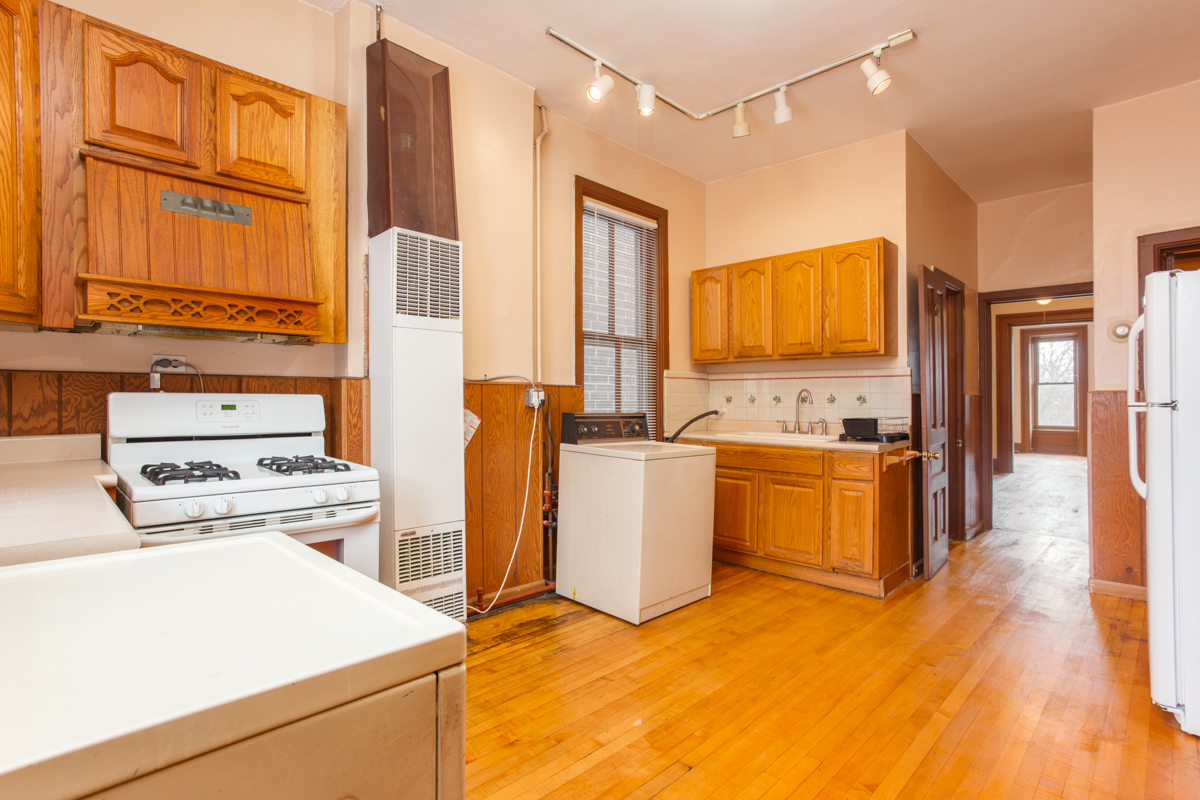 652 West Webster Avenue, Unit 2 Chicago, IL 60614 - Photo 6 of 11 a kitchen with a refrigerator and a stove top oven