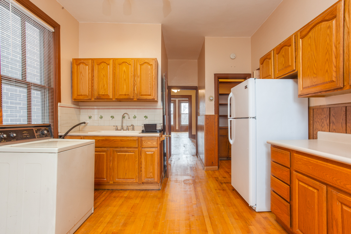 652 West Webster Avenue, Unit 2 Chicago, IL 60614 - Photo 7 of 11 a kitchen with stainless steel appliances granite countertop a refrigerator a stove and a sink