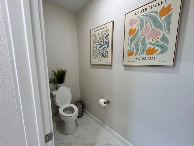 a bathroom with a toilet and a shower curtain
