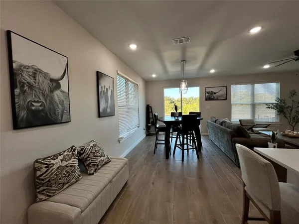 a living room with furniture and wooden floor