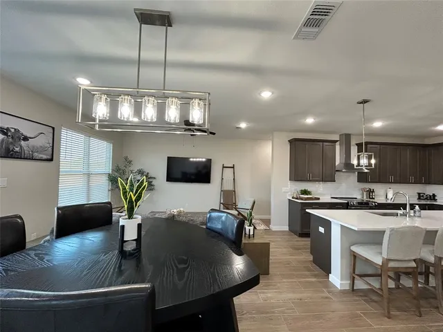 a kitchen with stainless steel appliances granite countertop a sink a stove top oven a counter space and cabinets