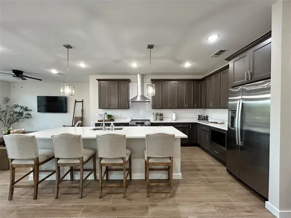 a large kitchen with a table and chairs