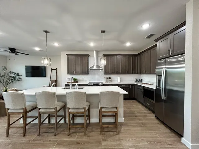 a large kitchen with a table and chairs