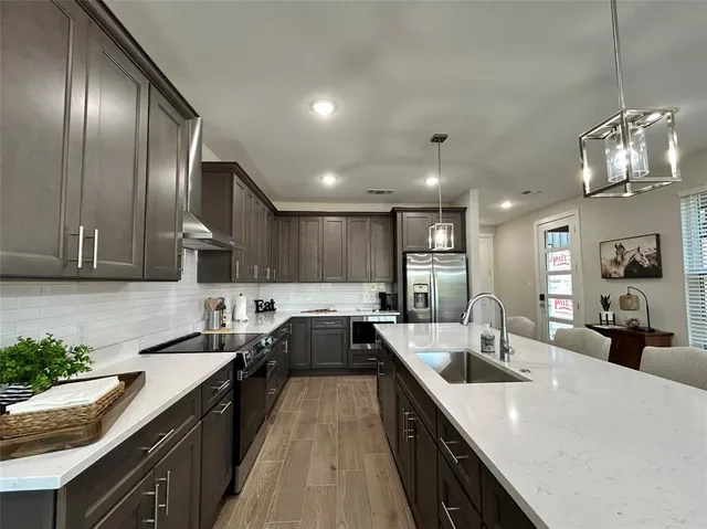a kitchen with lots of counter space a sink and appliances