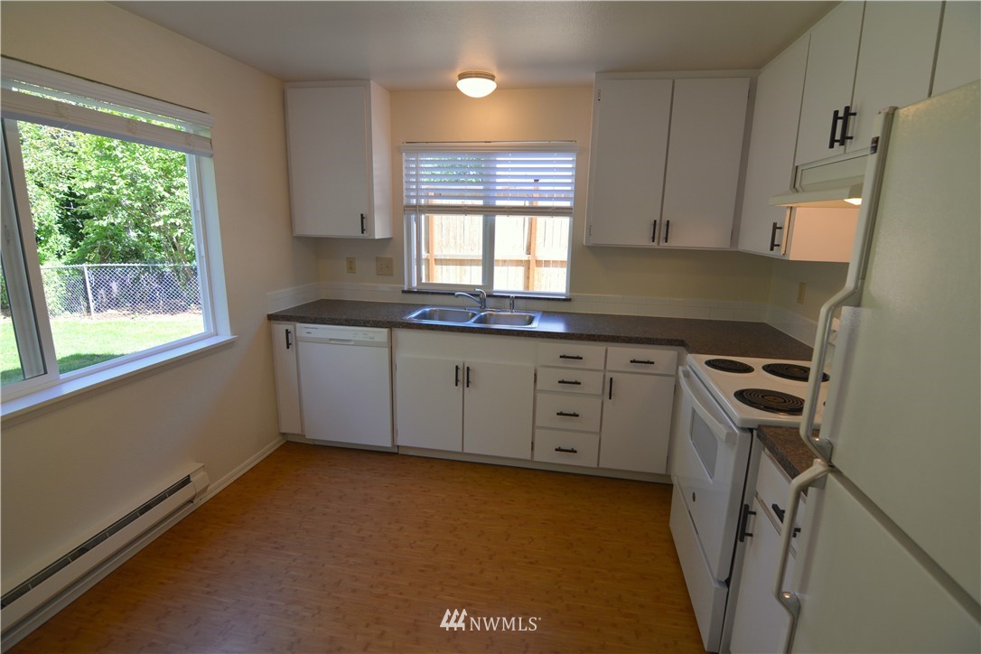 20515 Filbert Drive Bothell, WA 98012 - Photo 5 of 20 a kitchen that has a sink a window and stainless steel appliances