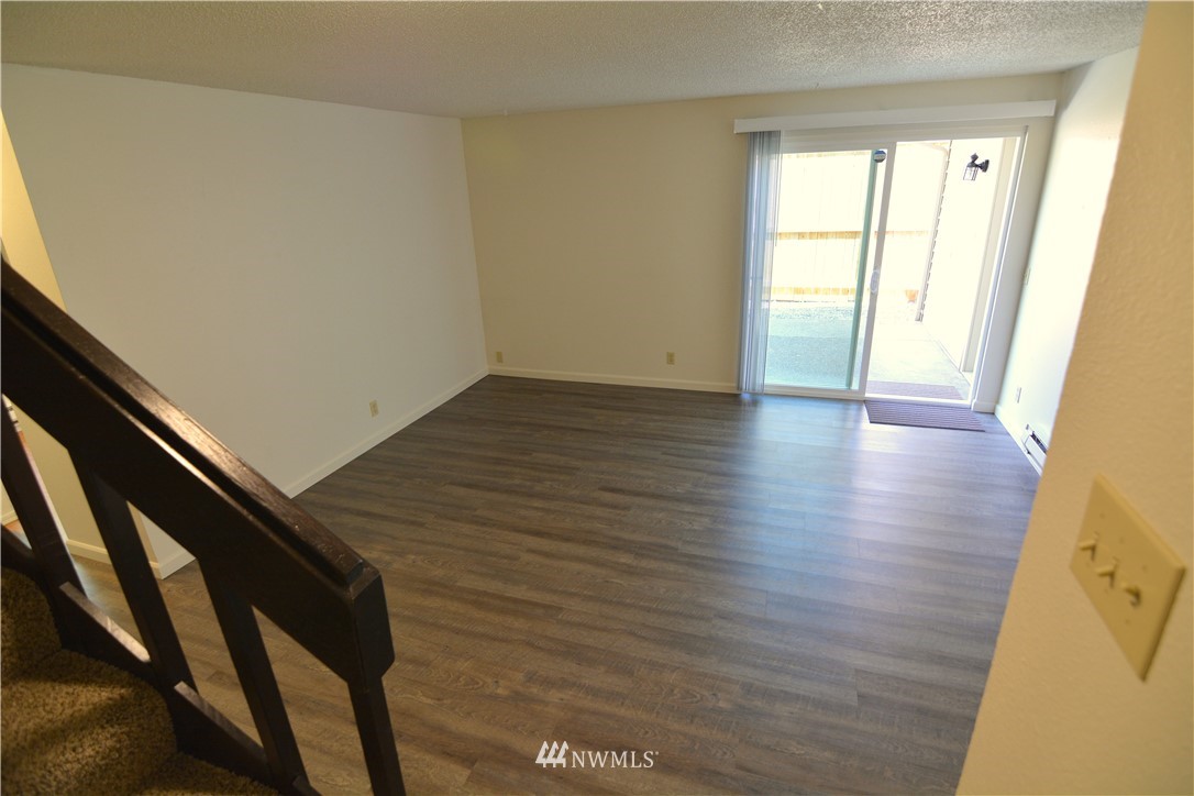 20515 Filbert Drive Bothell, WA 98012 - Photo 8 of 20 a view of an empty room and wooden floor