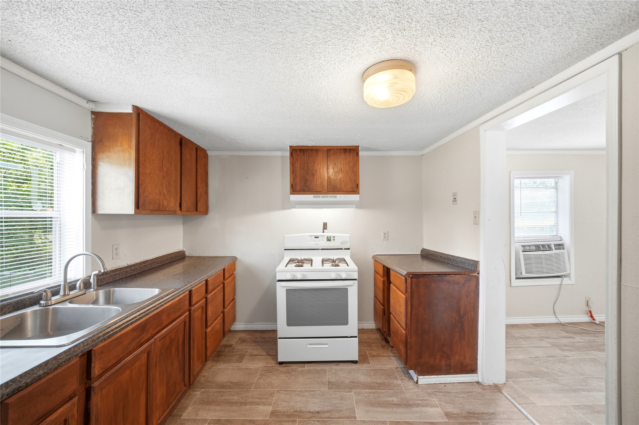 101 Outlar Street Wharton, TX 77488 - Photo 9 of 40 a kitchen with stainless steel appliances granite countertop a sink stove and refrigerator